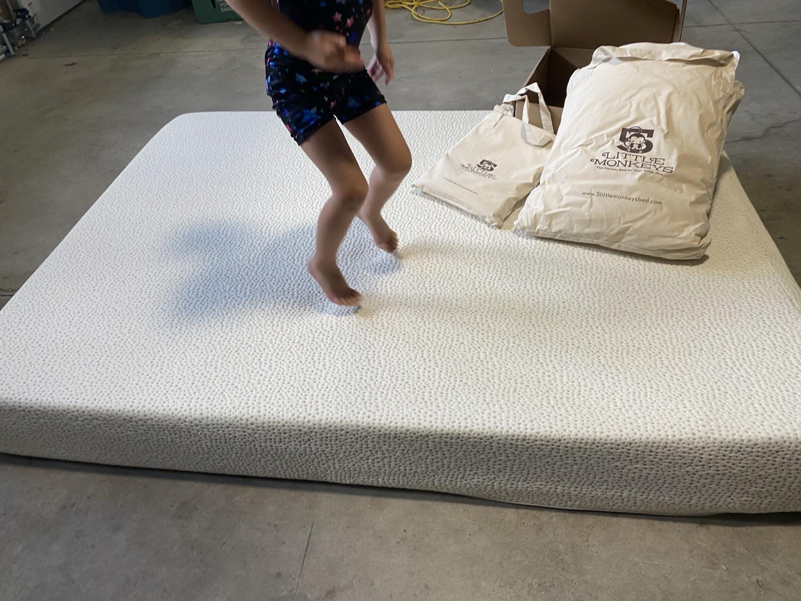 Kid jumping on 5 Little Monkeys mattress